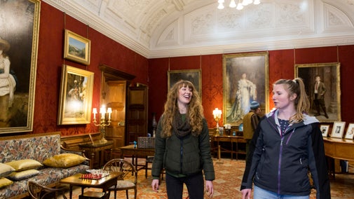 Visitors exploring the Drawing Room at Cragside, Northumberland